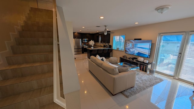 living area featuring recessed lighting, ceiling fan, stairway, and light tile patterned floors