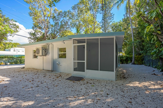 view of outbuilding featuring a sunroom