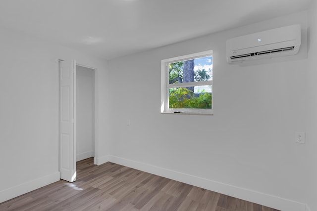 interior space featuring a wall unit AC and light wood-type flooring