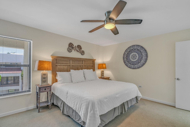601 W Ocean Dr Unit 414D, Key Colony, FL 33051 - bedroom featuring light colored carpet, multiple windows, baseboards, and ceiling fan