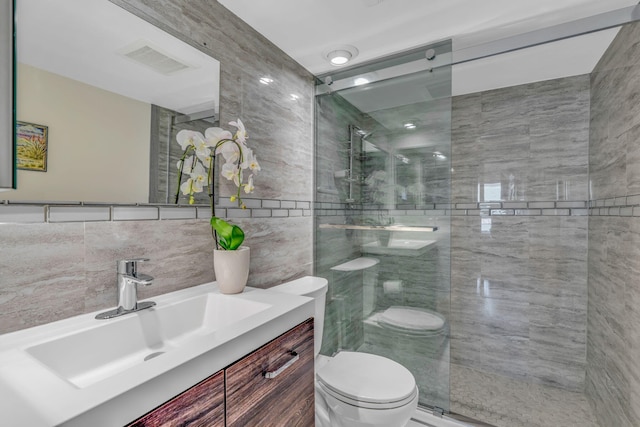 601 W Ocean Dr Unit 414D, Key Colony, FL 33051 - bathroom featuring toilet, vanity, a shower stall, and tile walls