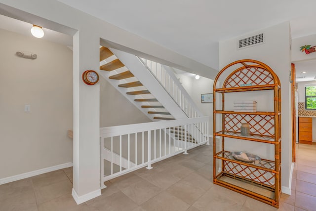 601 W Ocean Dr Unit 414D, Key Colony, FL 33051 - stairs featuring tile patterned floors and baseboards