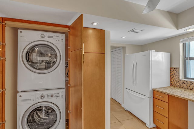 601 W Ocean Dr Unit 414D, Key Colony, FL 33051 - washroom with stacked washer and clothes dryer, light tile patterned flooring, and recessed lighting