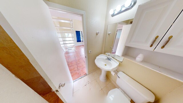 bathroom with tile patterned flooring and toilet