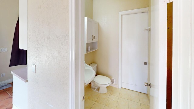 bathroom featuring tile patterned flooring and toilet