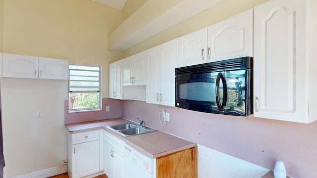 kitchen featuring white cabinetry, white dishwasher, and sink