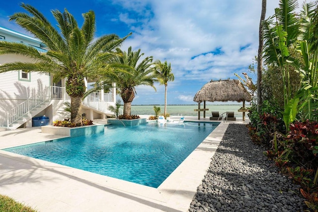 view of swimming pool featuring a gazebo and a water view