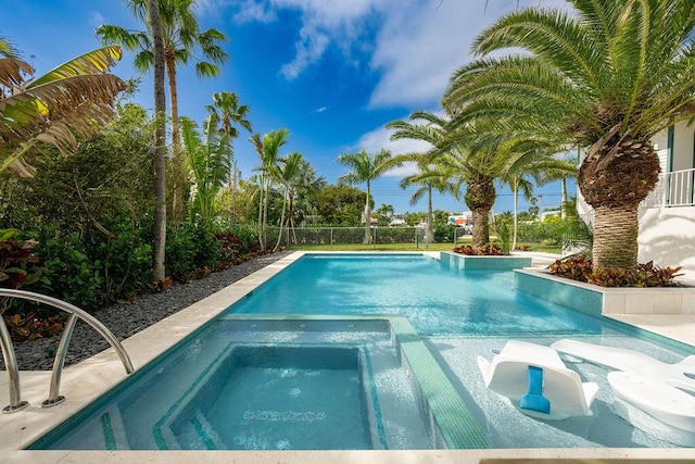 view of swimming pool featuring an in ground hot tub