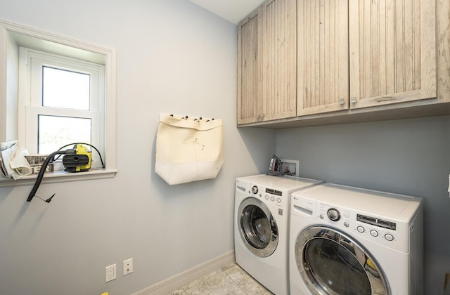 laundry room featuring cabinets and washing machine and dryer