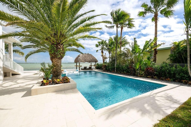 view of swimming pool with a gazebo, a water view, and a patio area