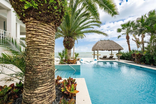 view of swimming pool with a gazebo and a water view