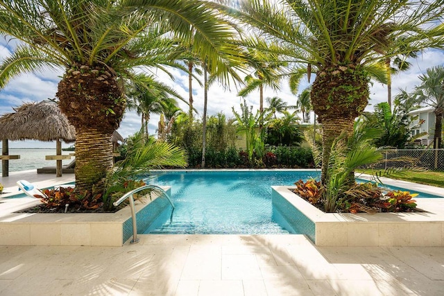 view of swimming pool featuring a water view