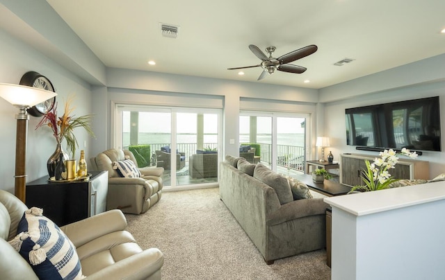 living room featuring light colored carpet and ceiling fan