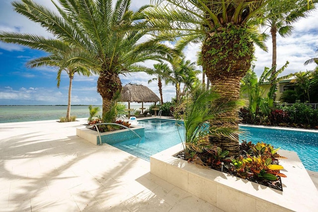 view of pool with a water view, a patio, and a gazebo