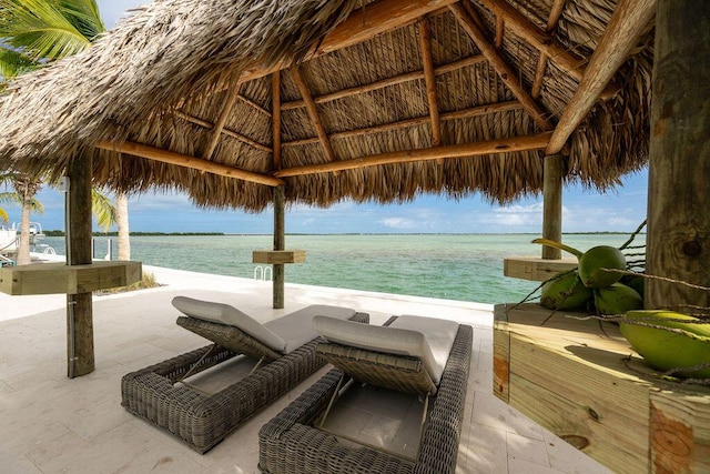 view of pool with a gazebo, a patio, a beach view, and a water view