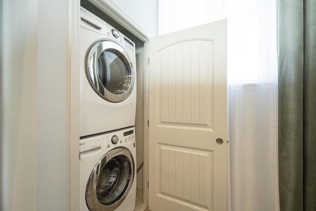 laundry room with stacked washer and dryer