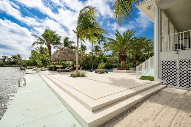 view of home's community featuring a pool, a gazebo, a water view, and a patio area