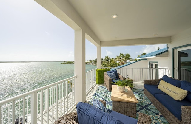 balcony featuring a water view and outdoor lounge area