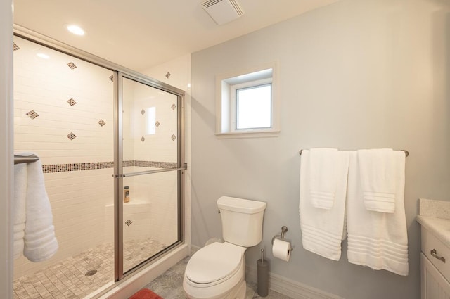 bathroom featuring vanity, toilet, and an enclosed shower