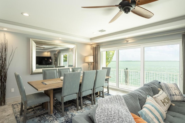 dining area with crown molding and ceiling fan