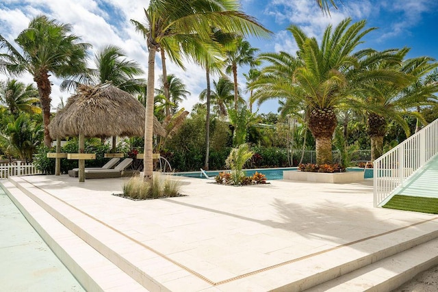 view of home's community featuring a pool, a gazebo, and a patio