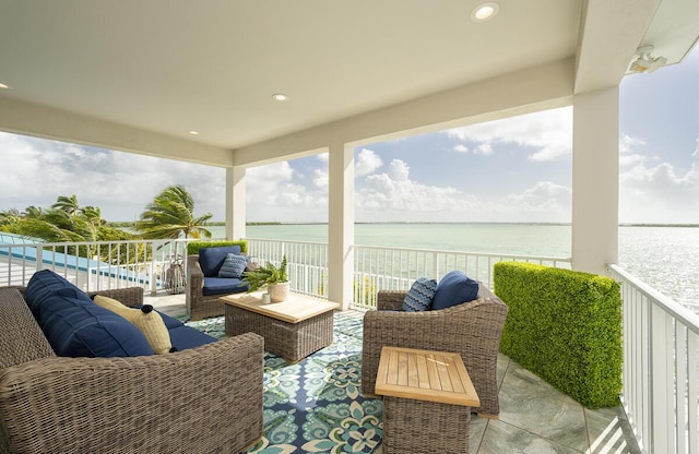 balcony featuring a water view and an outdoor living space