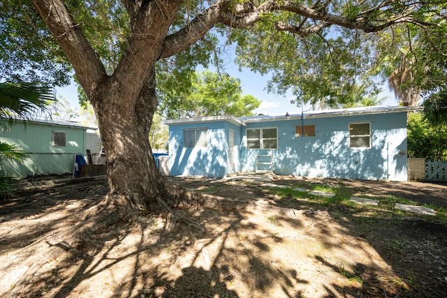 rear view of property with fence