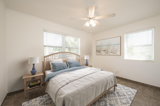 tiled bedroom with a ceiling fan, baseboards, and ornamental molding