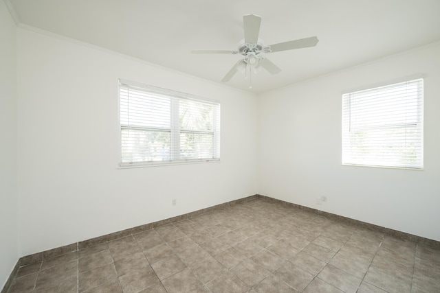 unfurnished room with baseboards, ornamental molding, and ceiling fan