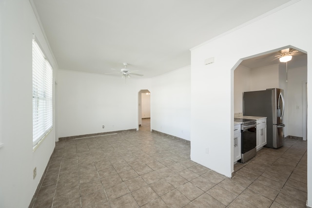 unfurnished room featuring crown molding, a ceiling fan, arched walkways, and light tile patterned floors