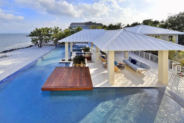 30 Ocean Front Dr, Key Largo, FL 33037 - view of swimming pool featuring a view of the beach, an outdoor living space, a gazebo, a water view, and a patio area