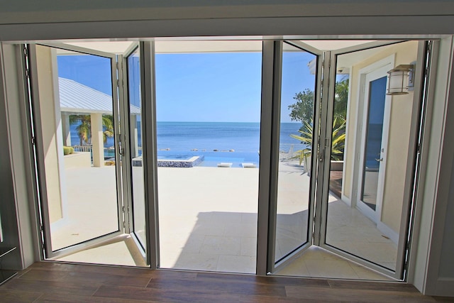 30 Ocean Front Dr, Key Largo, FL 33037 - entryway featuring dark hardwood / wood-style flooring, plenty of natural light, and a water view