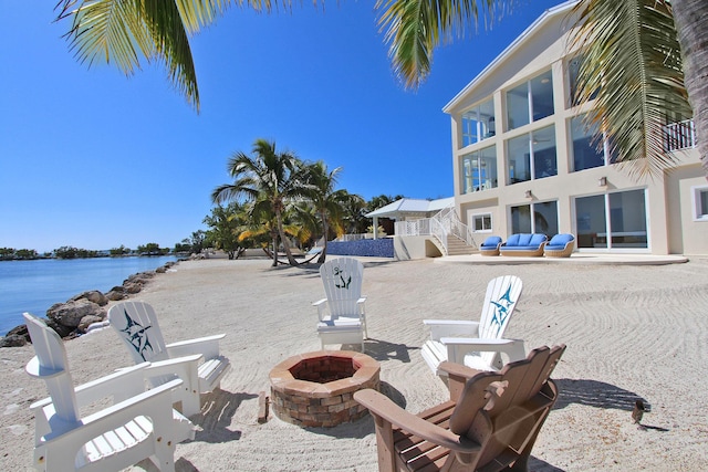 30 Ocean Front Dr, Key Largo, FL 33037 - view of patio with a water view and an outdoor fire pit