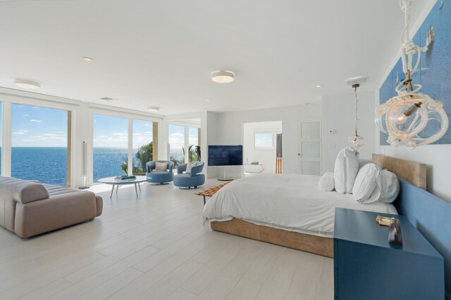 30 Ocean Front Dr, Key Largo, FL 33037 - bedroom with a water view, access to outside, and hardwood / wood-style floors