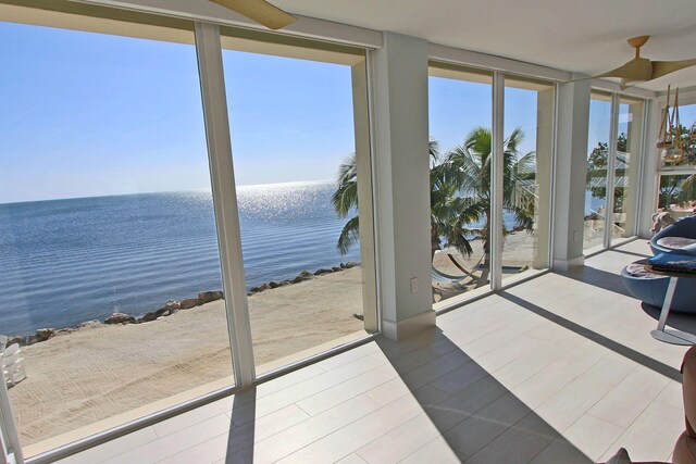 30 Ocean Front Dr, Key Largo, FL 33037 - entryway with a water view, expansive windows, wood-type flooring, and plenty of natural light