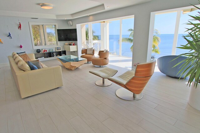30 Ocean Front Dr, Key Largo, FL 33037 - living room with light hardwood / wood-style flooring and a tray ceiling