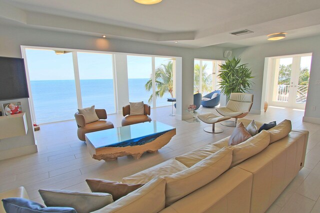 30 Ocean Front Dr, Key Largo, FL 33037 - living room featuring a water view, light hardwood / wood-style floors, and french doors
