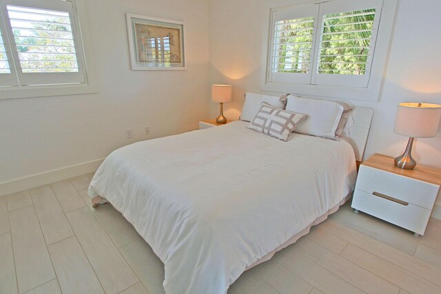 30 Ocean Front Dr, Key Largo, FL 33037 - bedroom featuring light hardwood / wood-style flooring