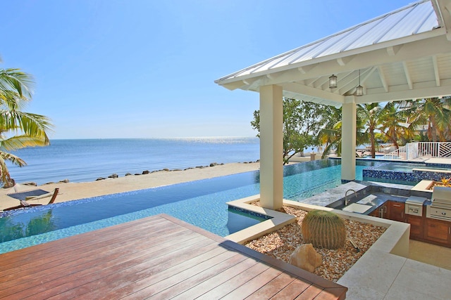 30 Ocean Front Dr, Key Largo, FL 33037 - view of dock with a water view, an outdoor kitchen, a swimming pool with hot tub, and a gazebo