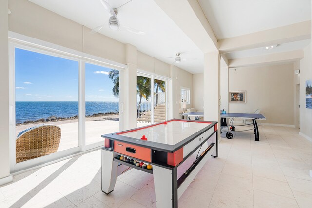30 Ocean Front Dr, Key Largo, FL 33037 - recreation room with light tile patterned flooring, a water view, ceiling fan, and a view of the beach