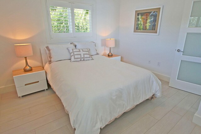 30 Ocean Front Dr, Key Largo, FL 33037 - bedroom with light hardwood / wood-style flooring