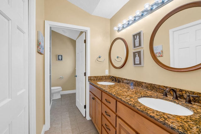 bathroom with vanity, tile patterned floors, and toilet