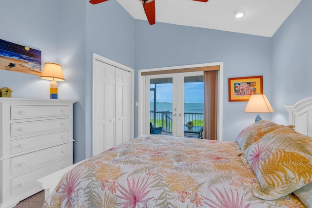 bedroom with vaulted ceiling, a water view, french doors, access to outside, and a closet