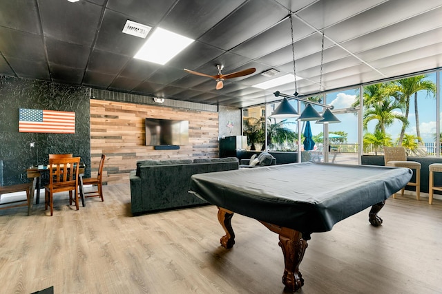 rec room with ceiling fan, a wall of windows, pool table, and hardwood / wood-style floors