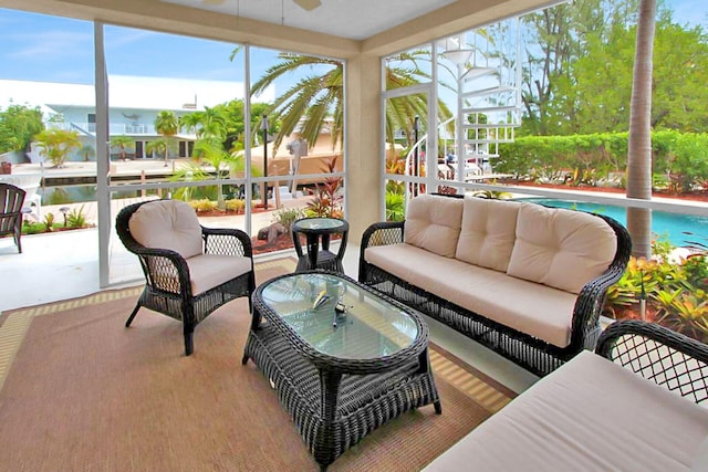 sunroom / solarium featuring ceiling fan