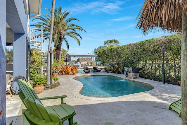 view of pool with a patio and pool water feature