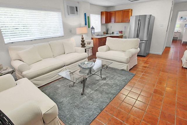 tiled living room featuring sink and a wall unit AC