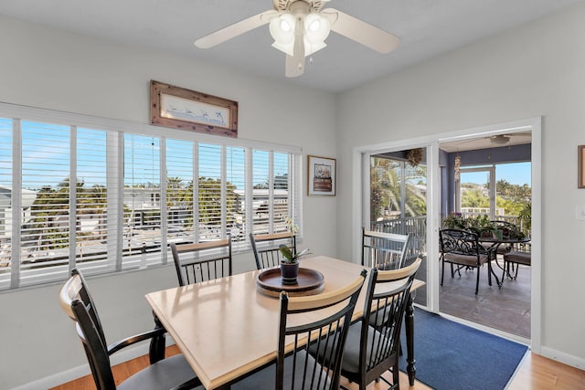 dining area with wood-type flooring, plenty of natural light, and ceiling fan