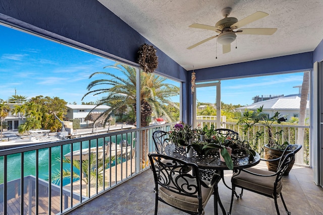 sunroom / solarium featuring ceiling fan