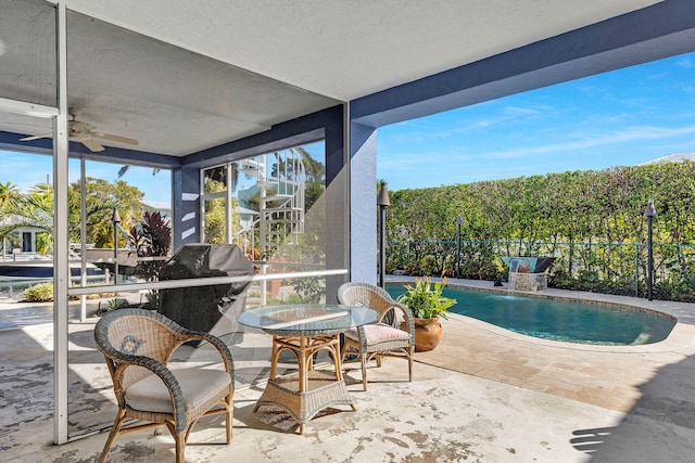 view of pool with a patio, pool water feature, area for grilling, and ceiling fan